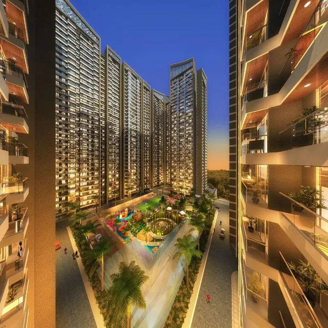 Night render of the Arihant Aspire tower cluster and landscaped podium